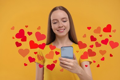 Long distance love. Woman chatting with sweetheart via smartphone on golden background. Hearts flying out of device and swirling around her