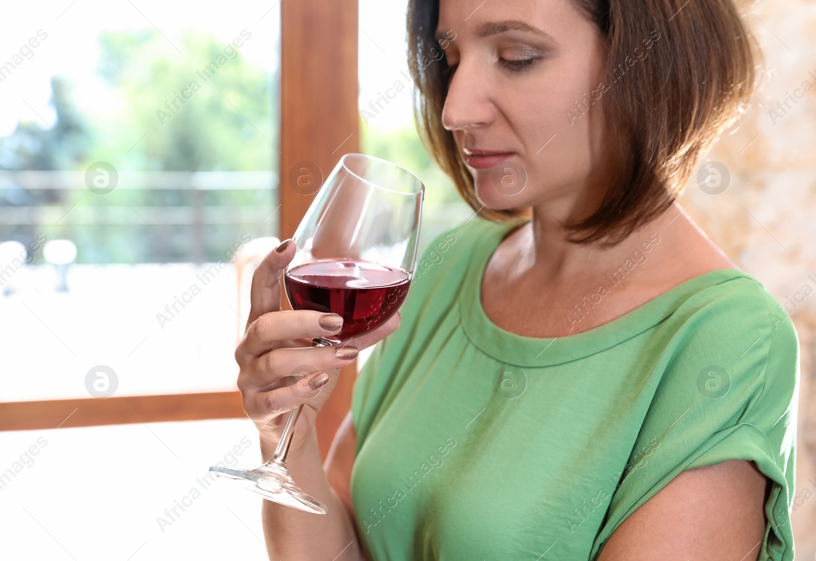 Photo of Woman with glass of red wine indoors