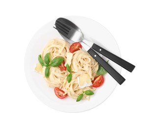 Photo of Delicious pasta with brie cheese, tomatoes, basil and cutlery isolated on white, top view