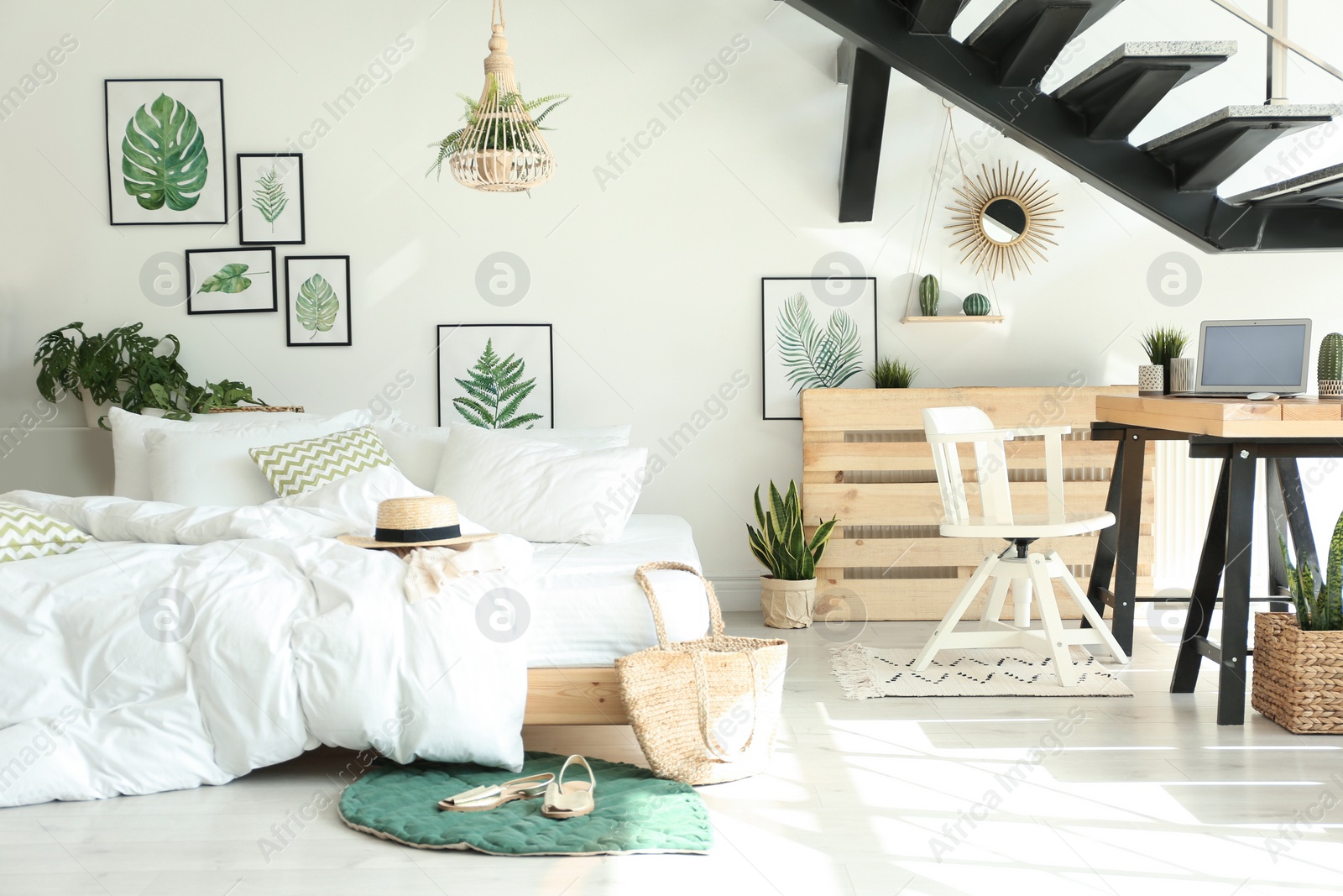 Photo of Elegant interior of bedroom with workplace under stairs