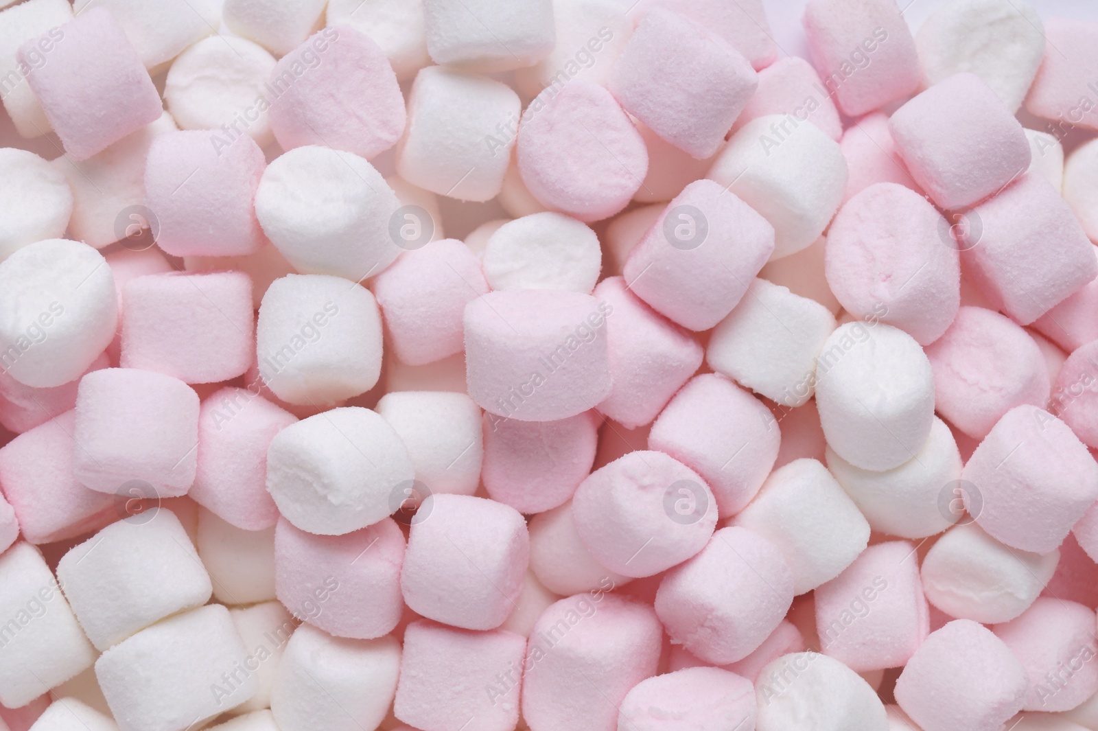 Photo of Delicious puffy pink and white marshmallows as background, top view