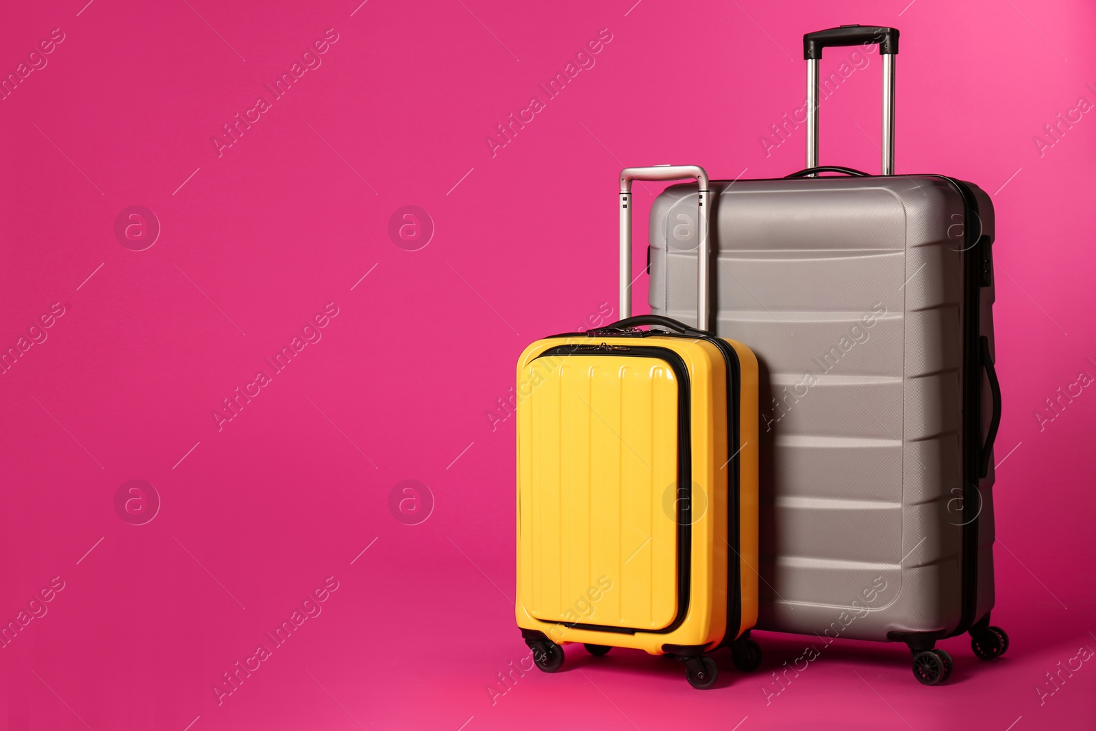 Photo of Stylish suitcases on color background. Space for text