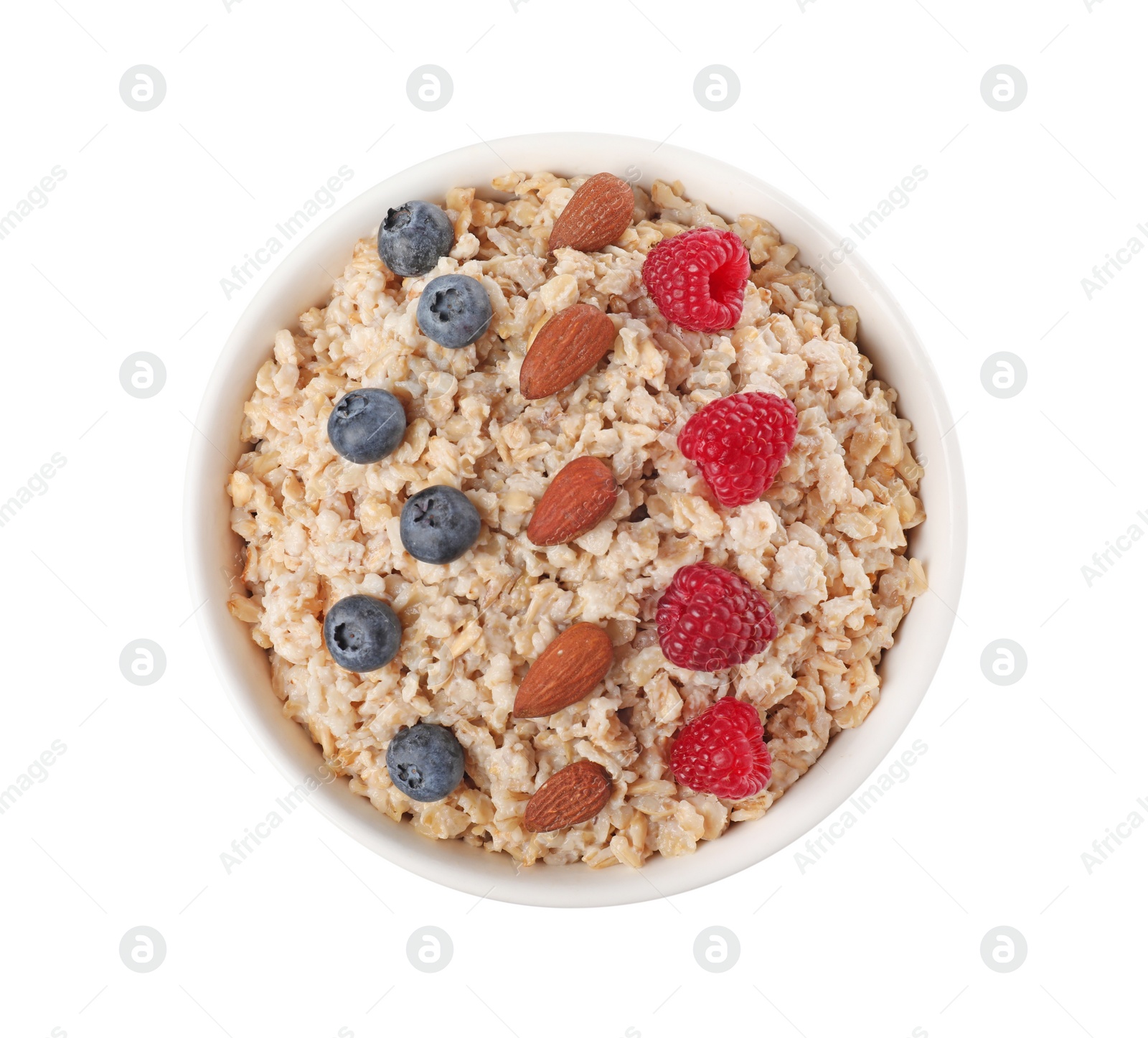 Photo of Tasty boiled oatmeal with berries and almonds in bowl isolated on white, top view