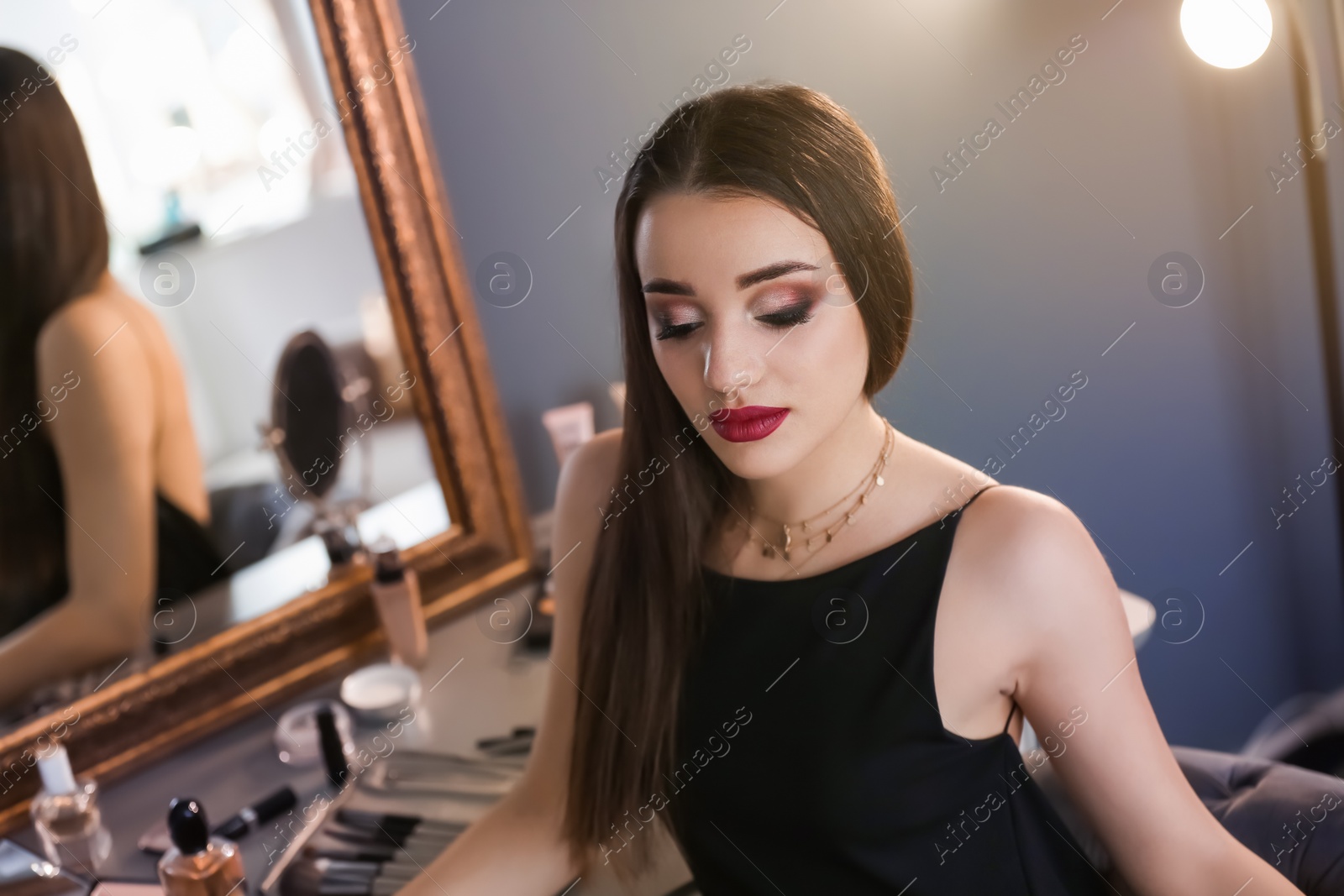 Photo of Portrait of beautiful woman with bright makeup indoors
