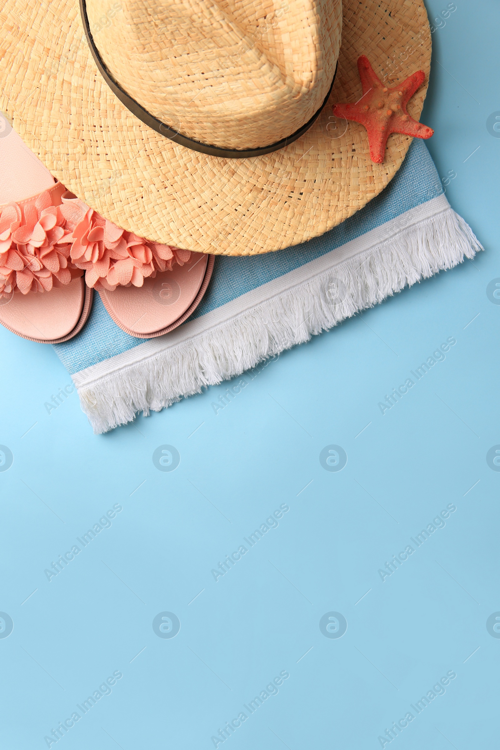 Photo of Flat lay composition with beach accessories on light blue background, space for text