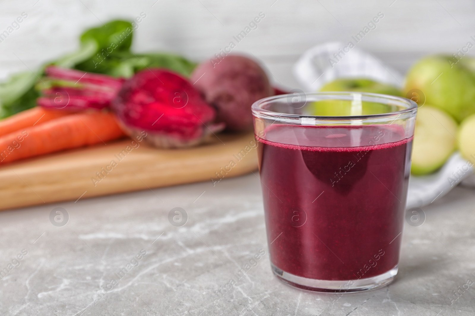 Photo of Glass of fresh beet juice on table