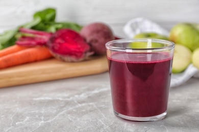 Photo of Glass of fresh beet juice on table