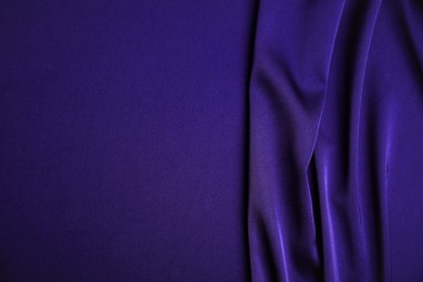 Image of Crumpled purple silk fabric as background, top view. Space for text