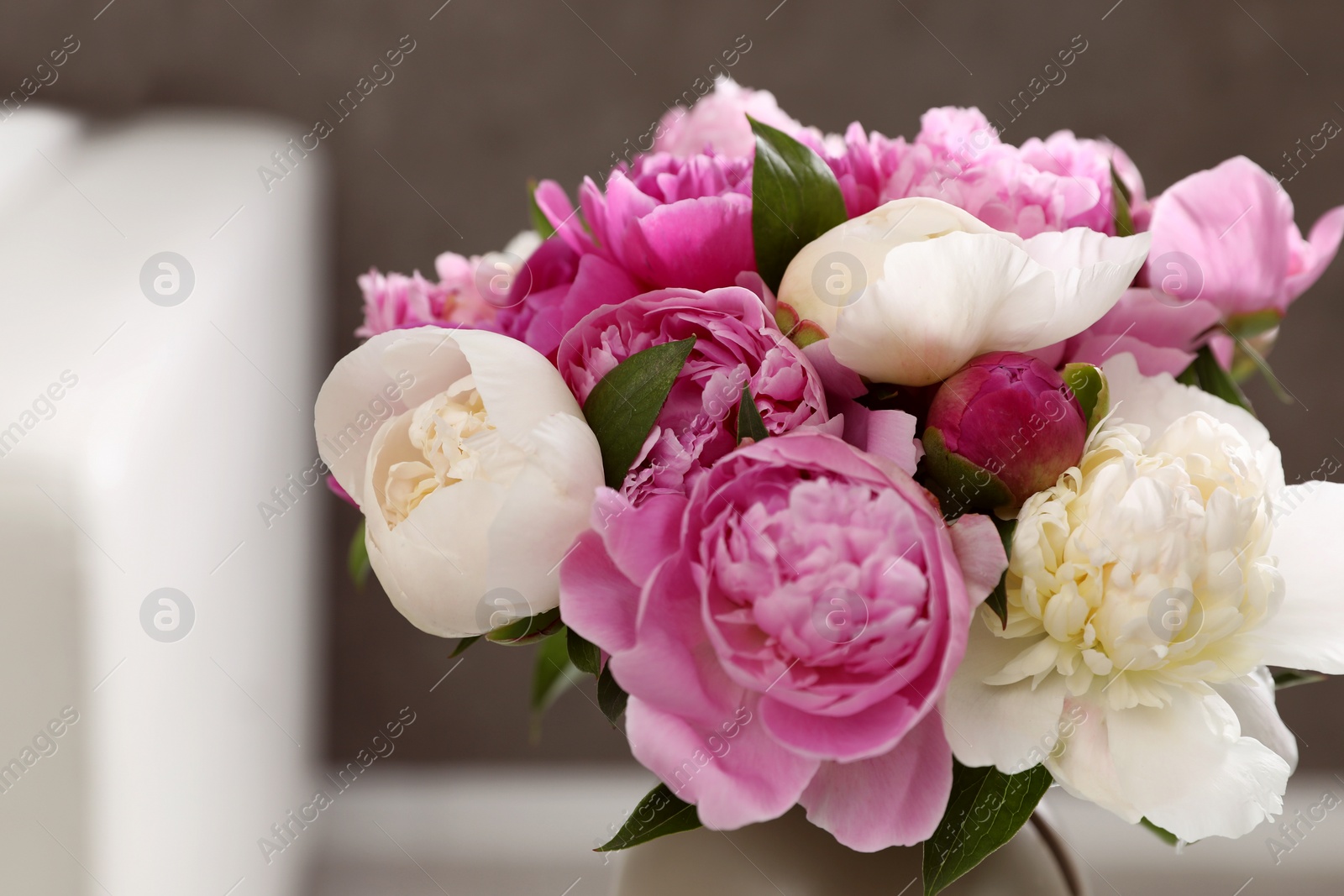 Photo of Bouquet of beautiful peonies in room, closeup