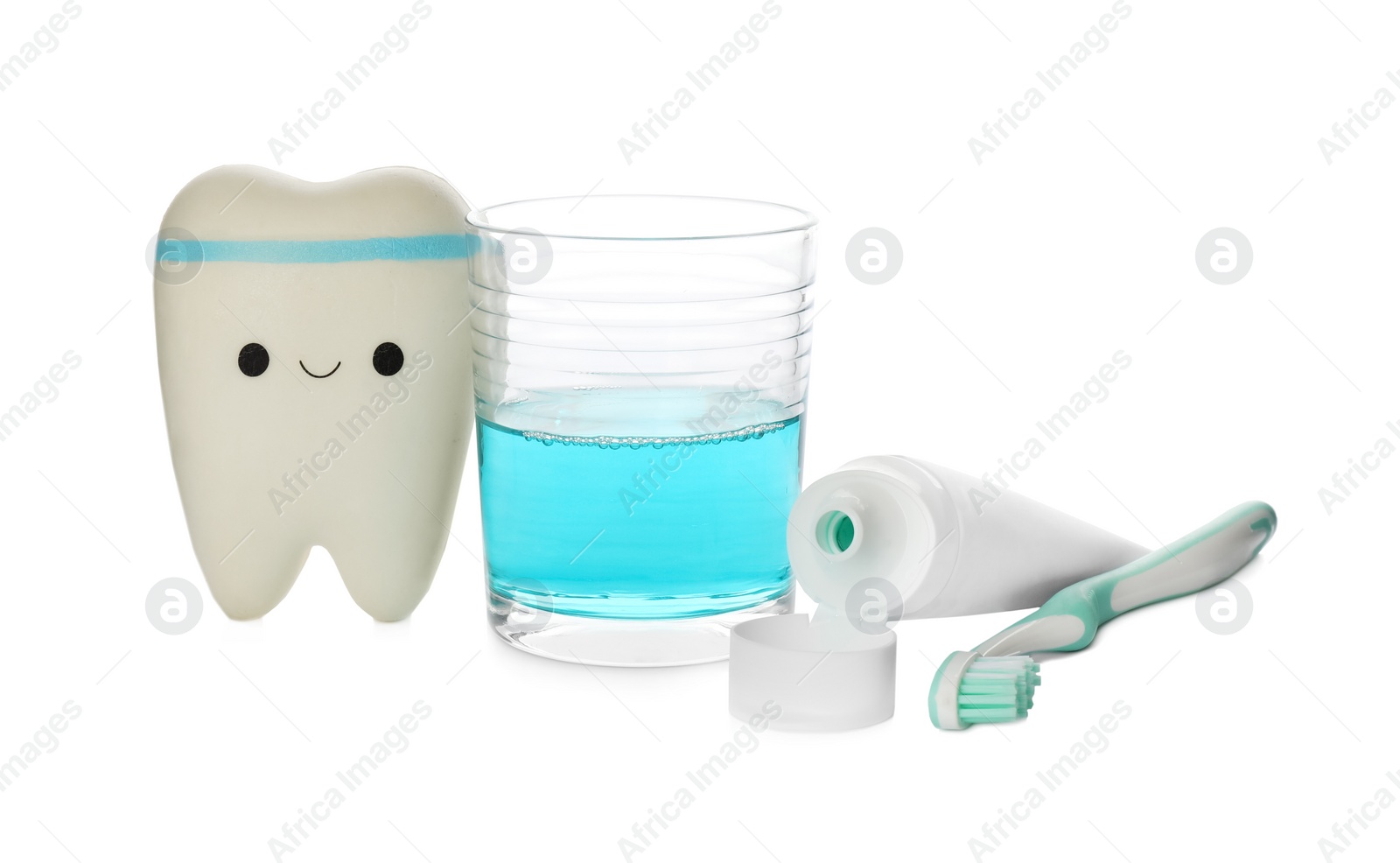 Photo of Mouthwash, toothbrush, paste and holder on white background