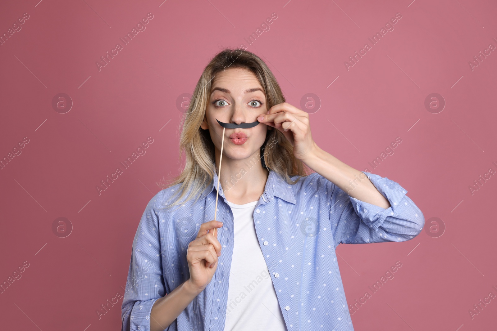 Photo of Emotional woman with fake mustache on dusty rose background