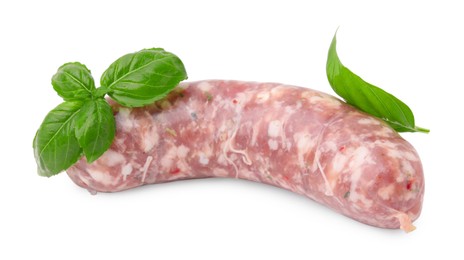 Photo of Raw homemade sausage and basil leaves isolated on white