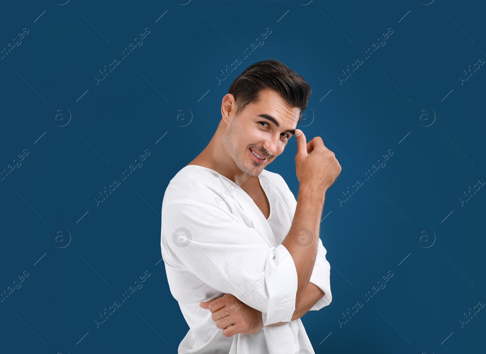 Photo of Portrait of handsome young man on blue background