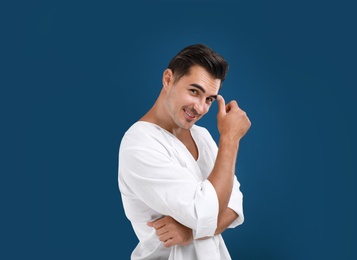 Photo of Portrait of handsome young man on blue background