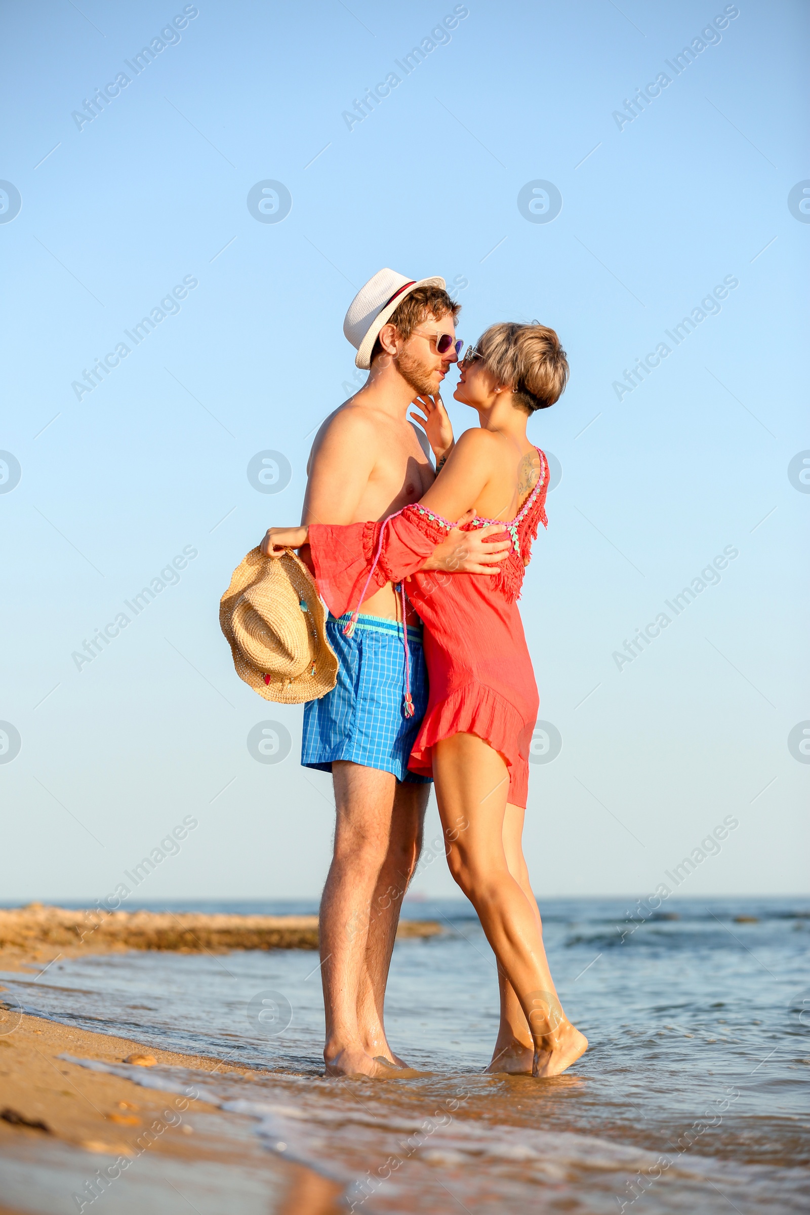 Photo of Happy young couple near water on beach