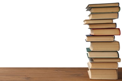 Photo of Stack of books on wooden table against white background. Library material