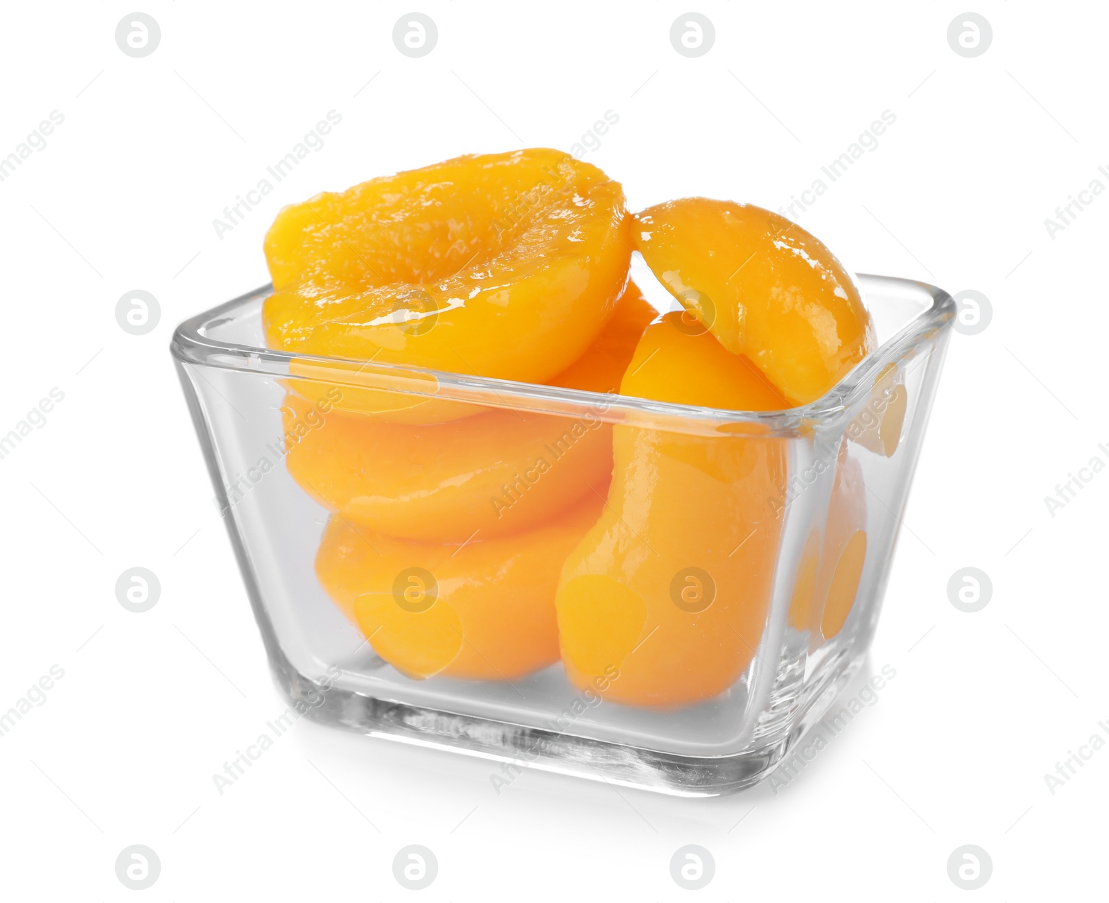 Photo of Bowl with halves of canned peaches on white background