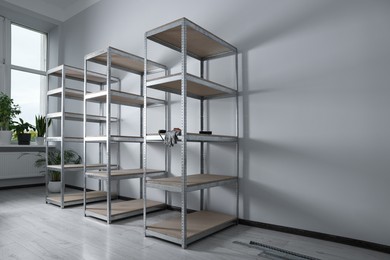 Photo of Office room with white walls and metal storage shelves