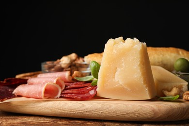 Snack platter with parmesan cheese served on wooden table, closeup