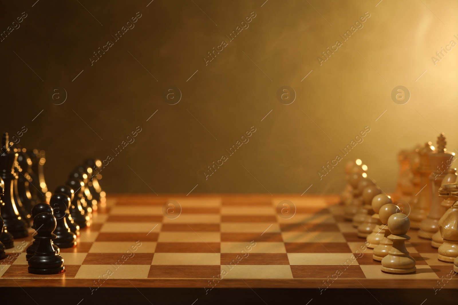 Photo of Black and white chess pieces on checkerboard before game. Space for text