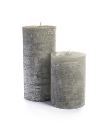 Photo of Two decorative wax candles on white background