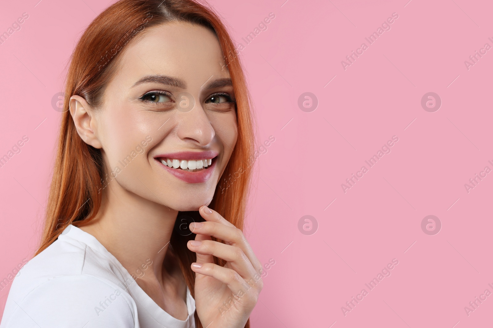 Photo of Portrait of beautiful young woman on pink background, space for text