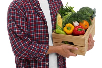 Harvesting season. Farmer holding wooden crate with vegetables on white background, closeup