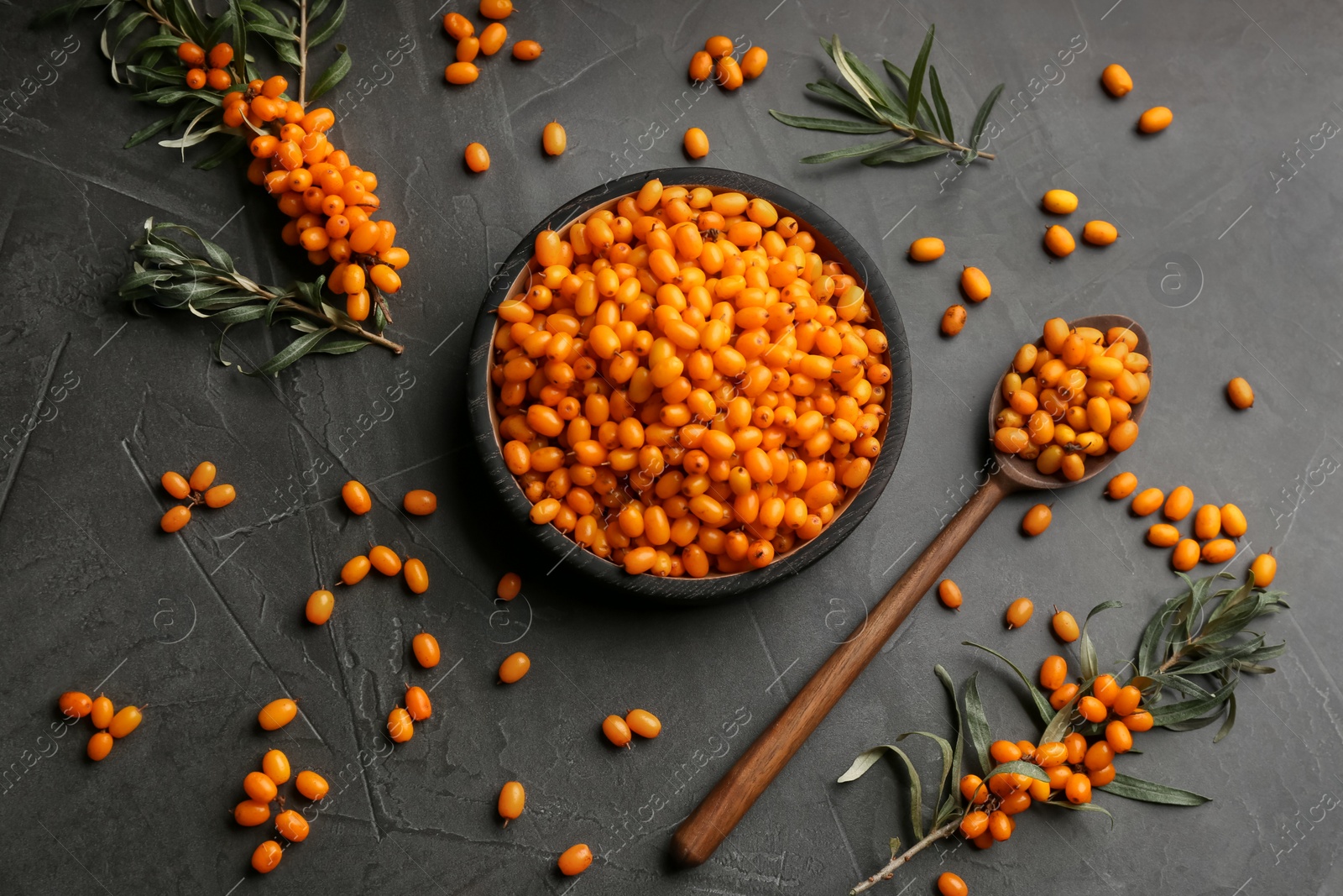 Photo of Fresh ripe sea buckthorn on black table, flat lay