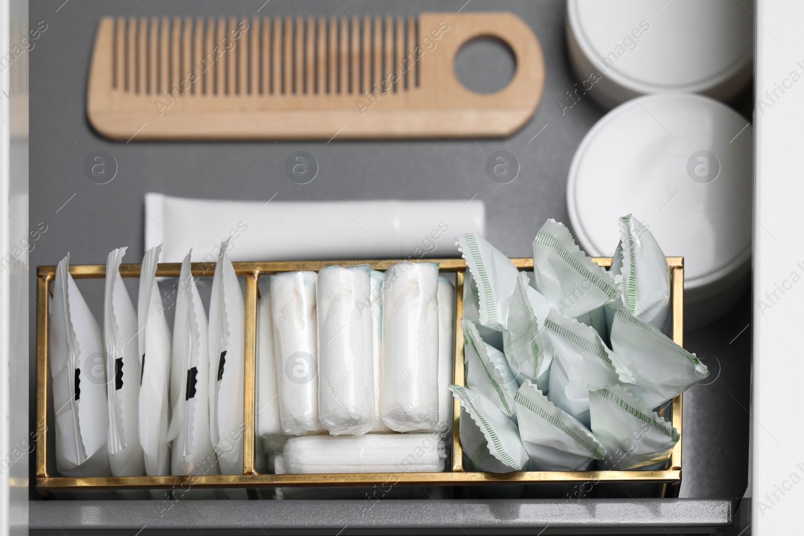 Photo of Storage of different feminine and personal care products in drawer, above view