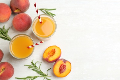Photo of Natural freshly made peach juice on white table, flat lay. Space for text
