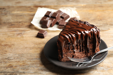 Tasty chocolate cake served on wooden table