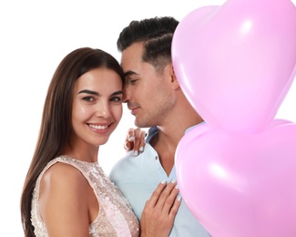 Photo of Beautiful couple with heart shaped balloons on white background