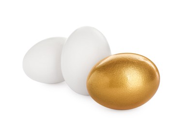Photo of Golden egg and ordinary ones on white background