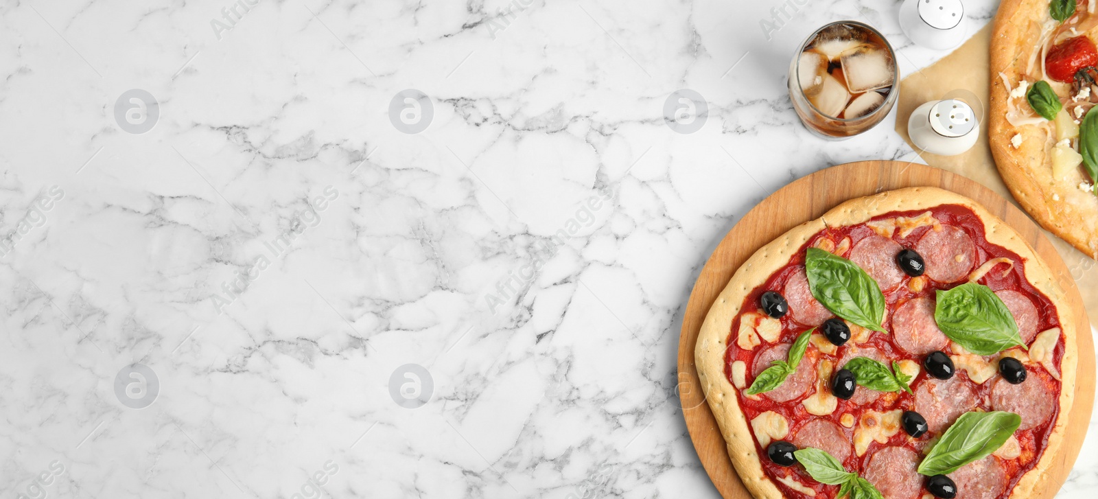 Image of Delicious homemade pita pizza and cold drink on white marble table, flat lay with space for text. Banner design