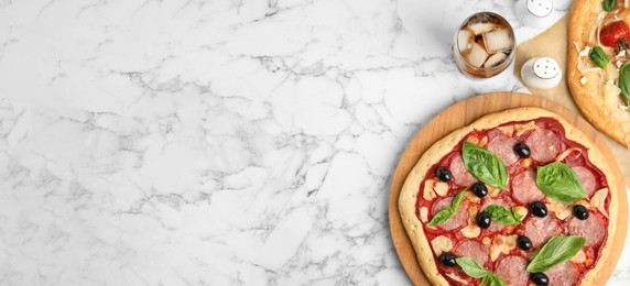 Delicious homemade pita pizza and cold drink on white marble table, flat lay with space for text. Banner design