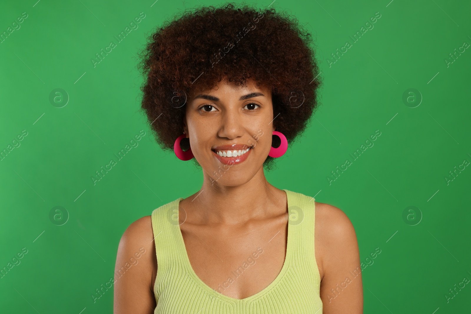 Photo of Portrait of happy young woman on green background