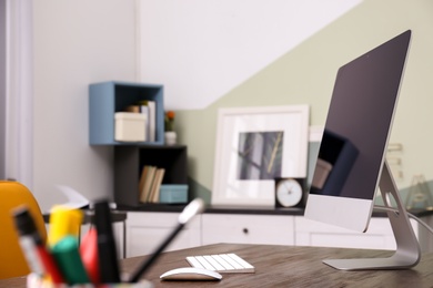 Photo of Comfortable workplace with computer on desk in home office