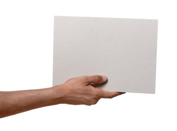 Photo of Man holding sheet of paper on white background, closeup. Mockup for design