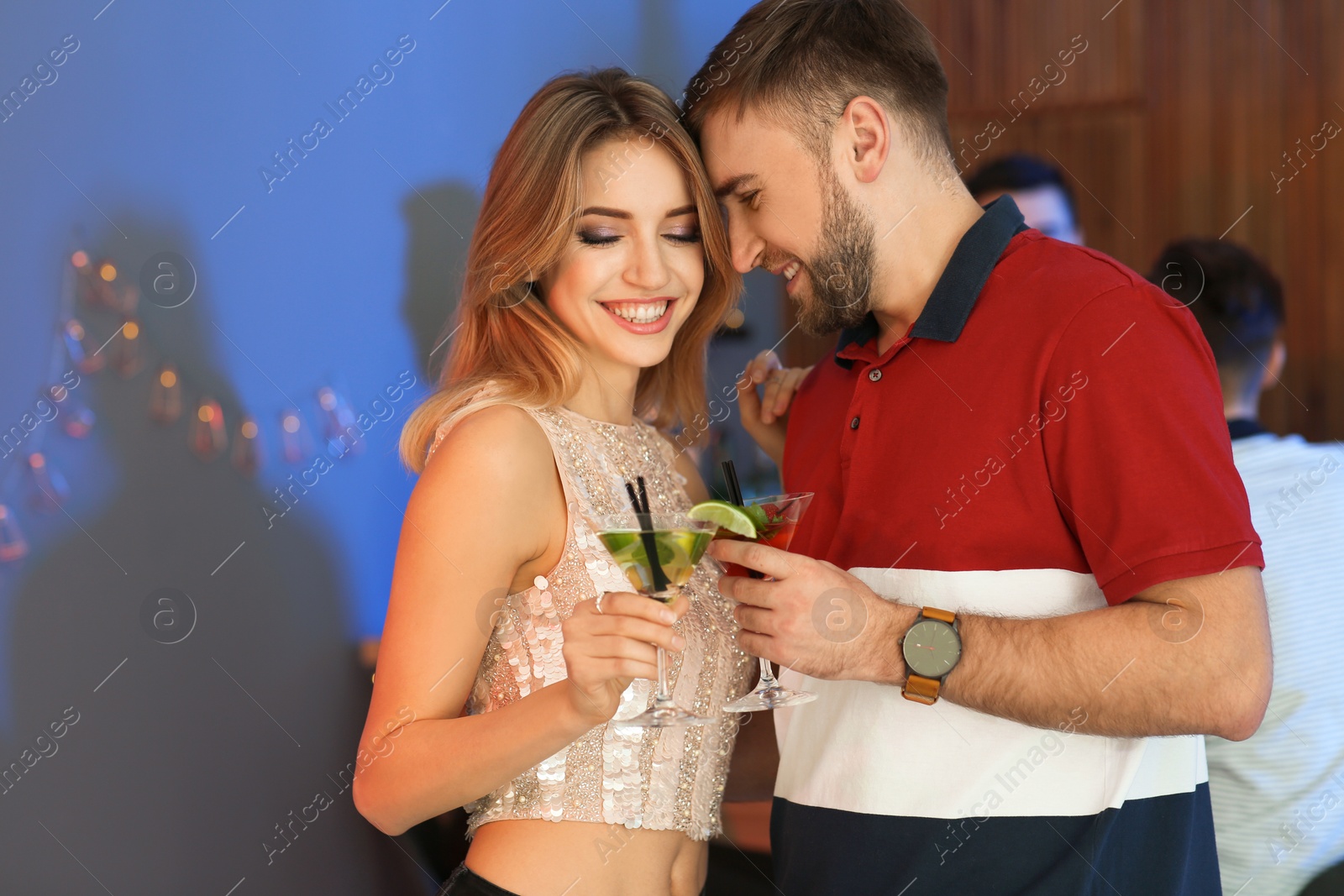 Photo of Young couple with martini cocktails at party