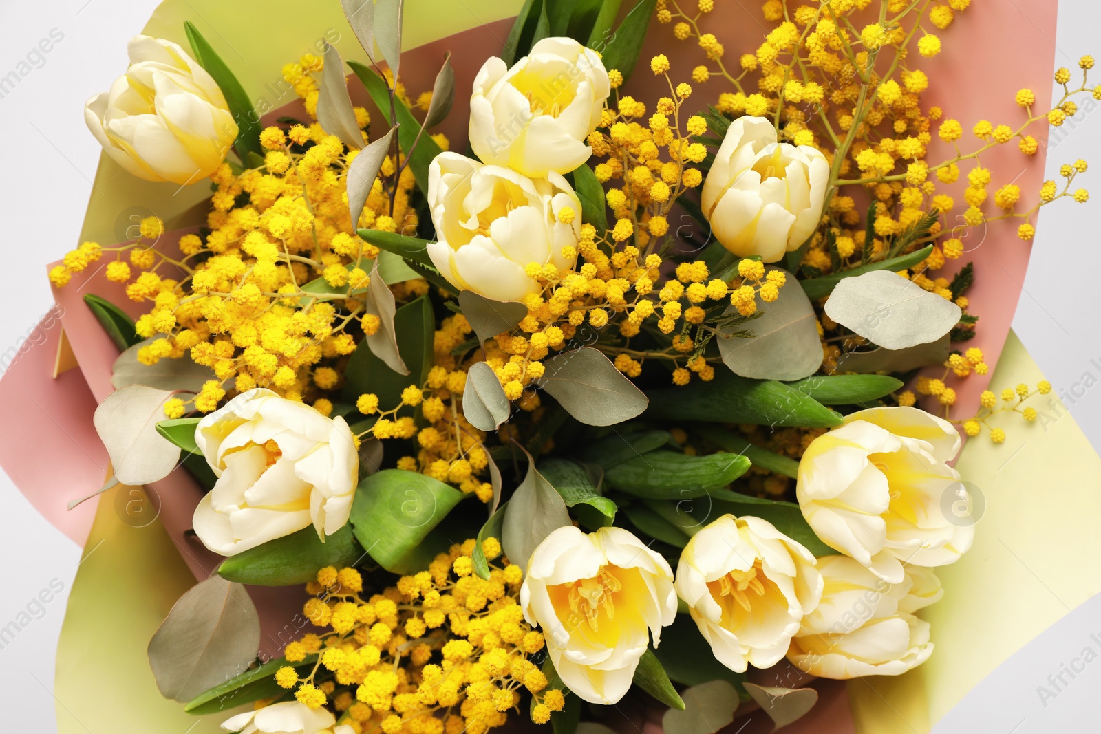 Photo of Bouquet of beautiful spring flowers on light grey background, top view