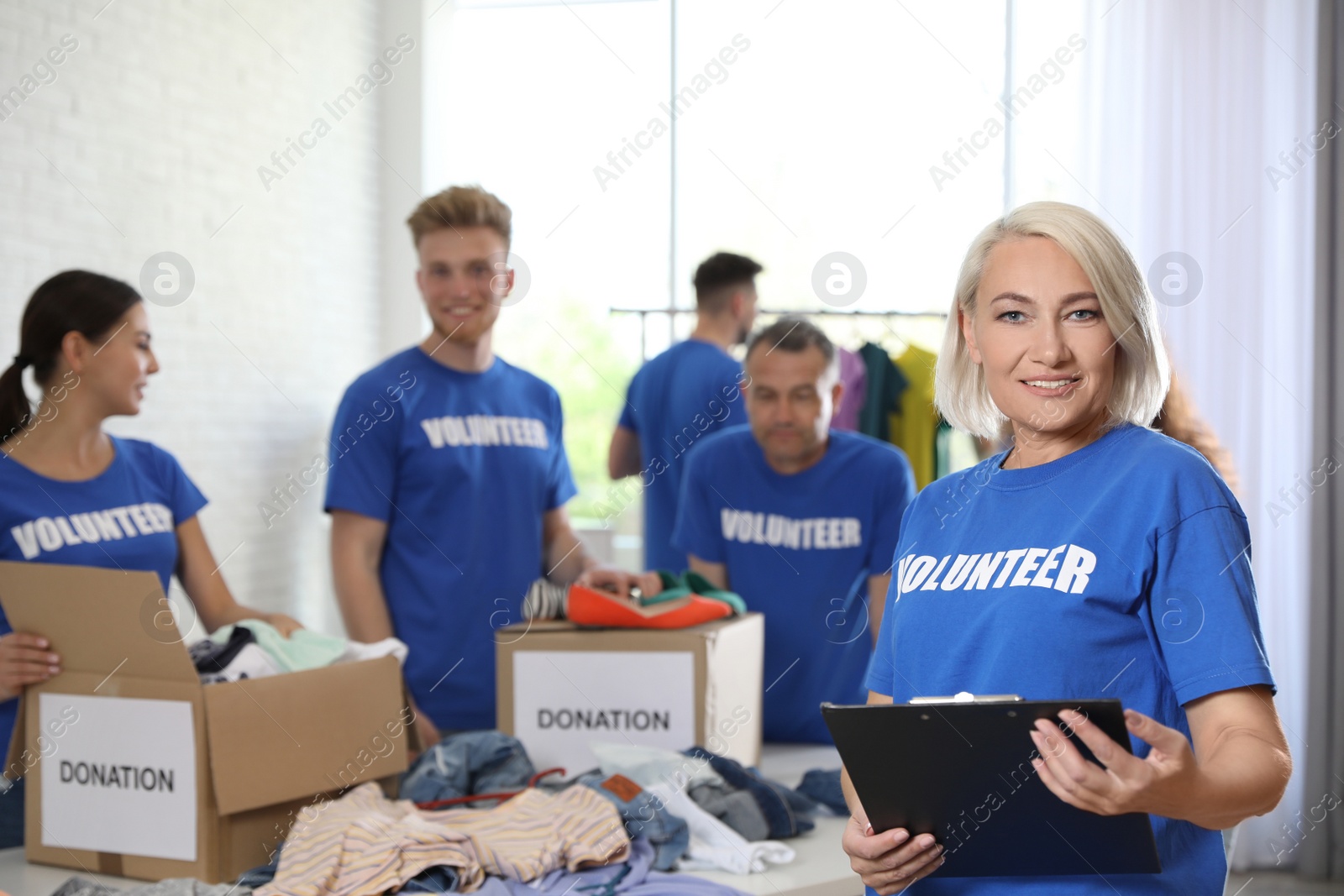 Photo of Portrait of happy female volunteer in uniform indoors