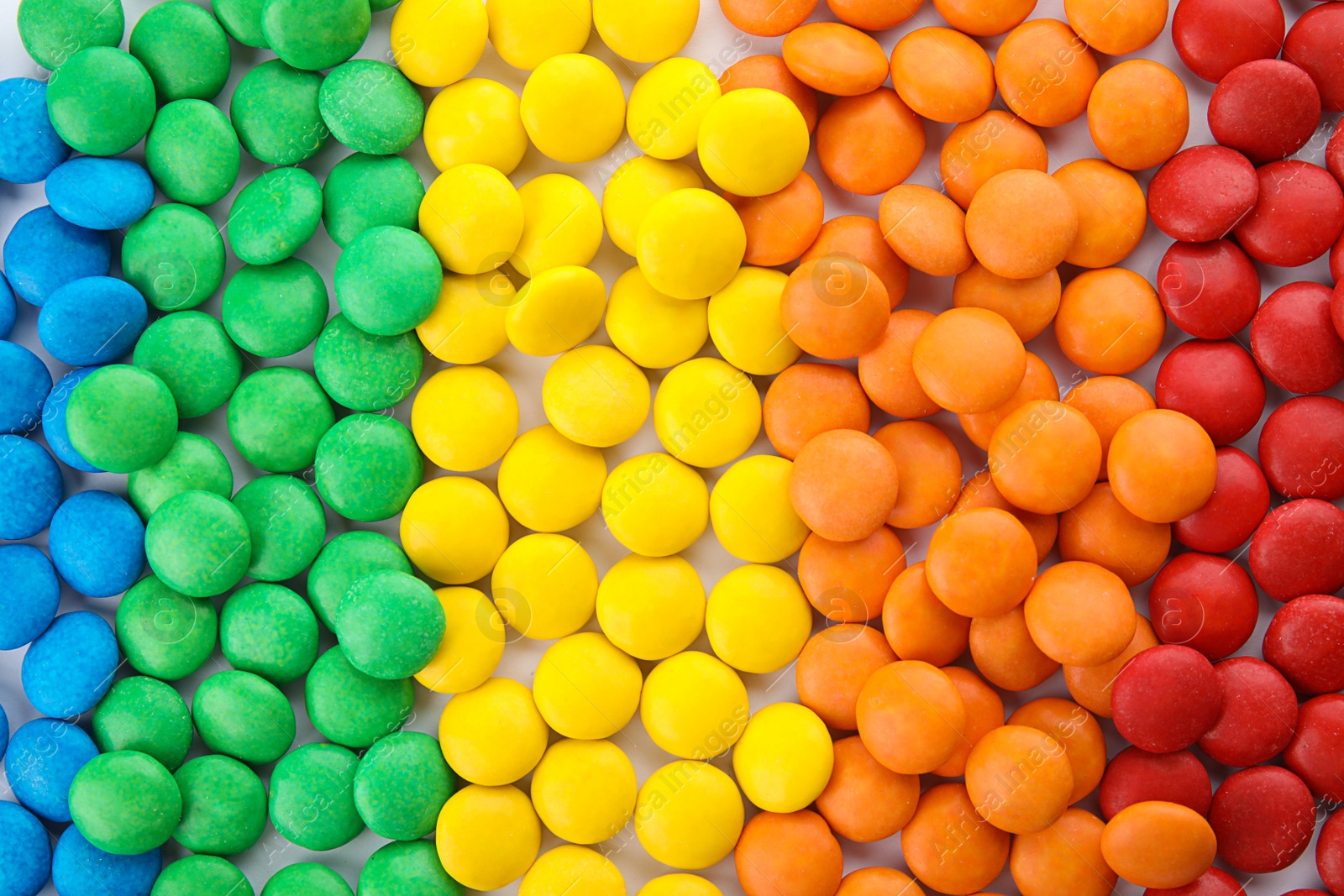 Photo of Many colorful candies as background, top view