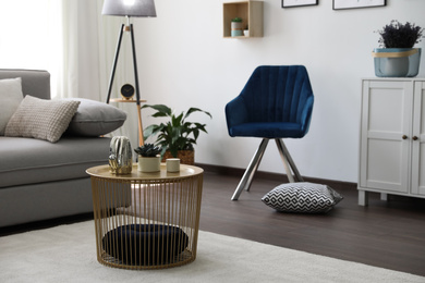 Decorative table near sofa in living room. Interior design