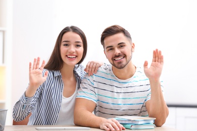 Happy couple using video chat for conversation indoors