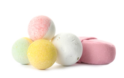 Bath bombs and sponge on white background