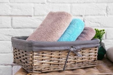 Wicker basket with clean towels in bathroom