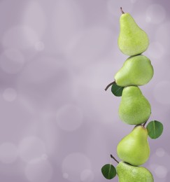 Image of Whole fresh ripe pears on pale violet background, space for text