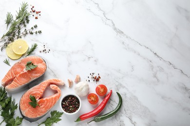 Photo of Fresh salmon and ingredients for marinade on white marble table, flat lay. Space for text