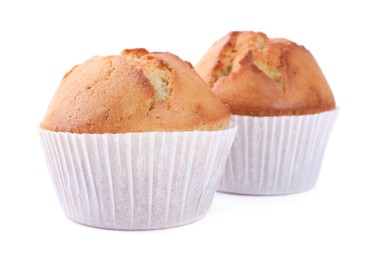 Tasty muffins in paper cups on white background