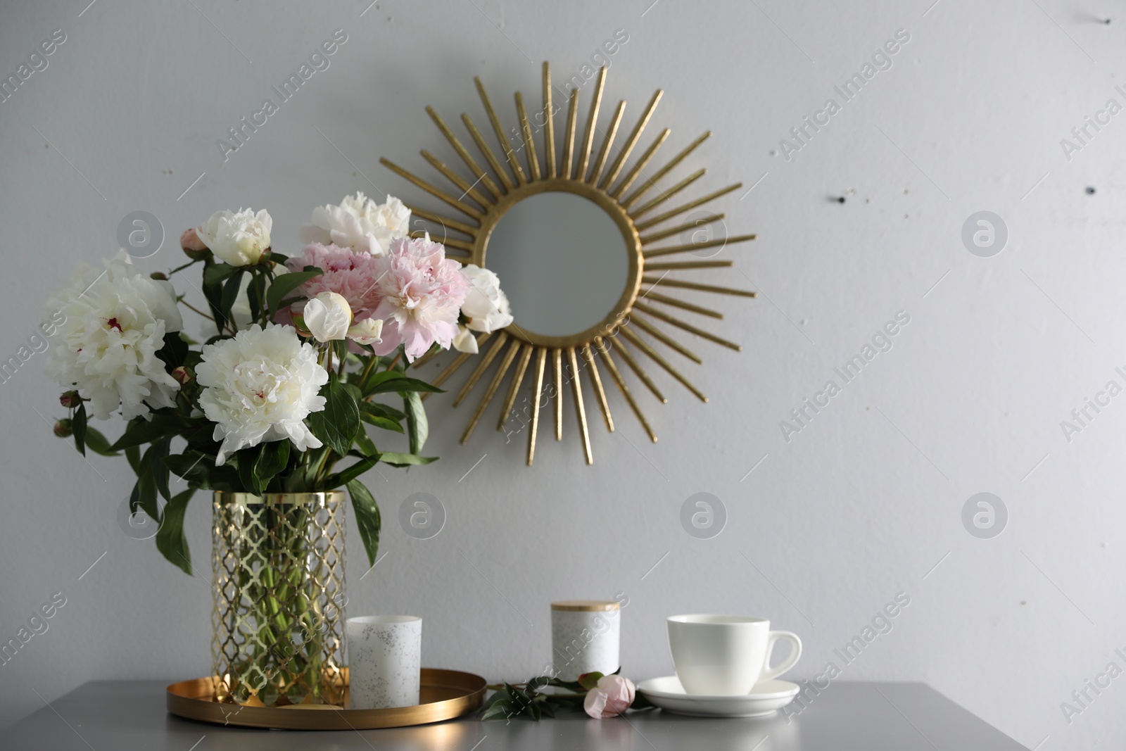 Photo of Bouquet of beautiful peony flowers on table indoors